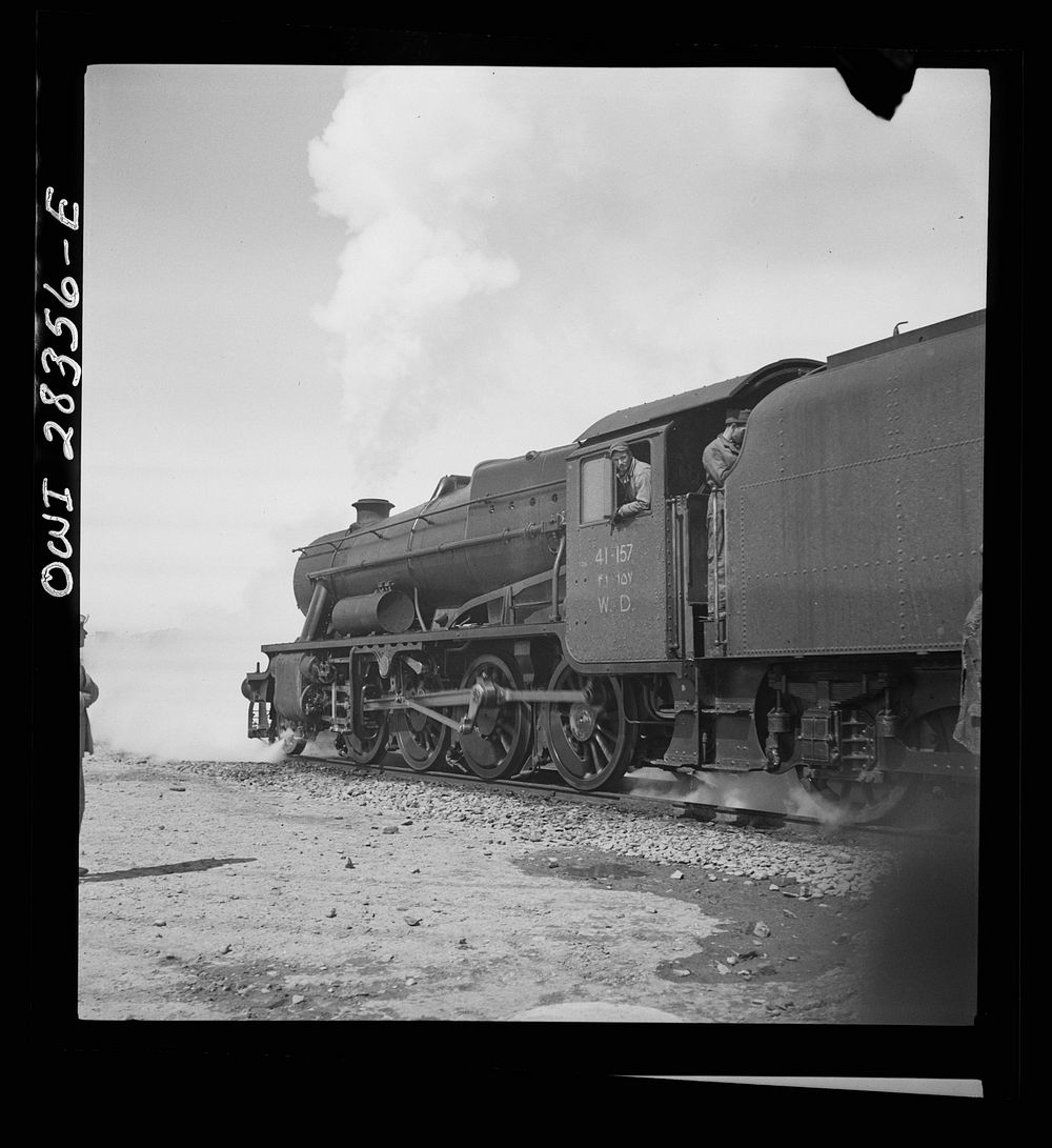 An American locomotive with an American soldier crew hauling freight to Russia somewhere in Iran. Sourced from the Library…