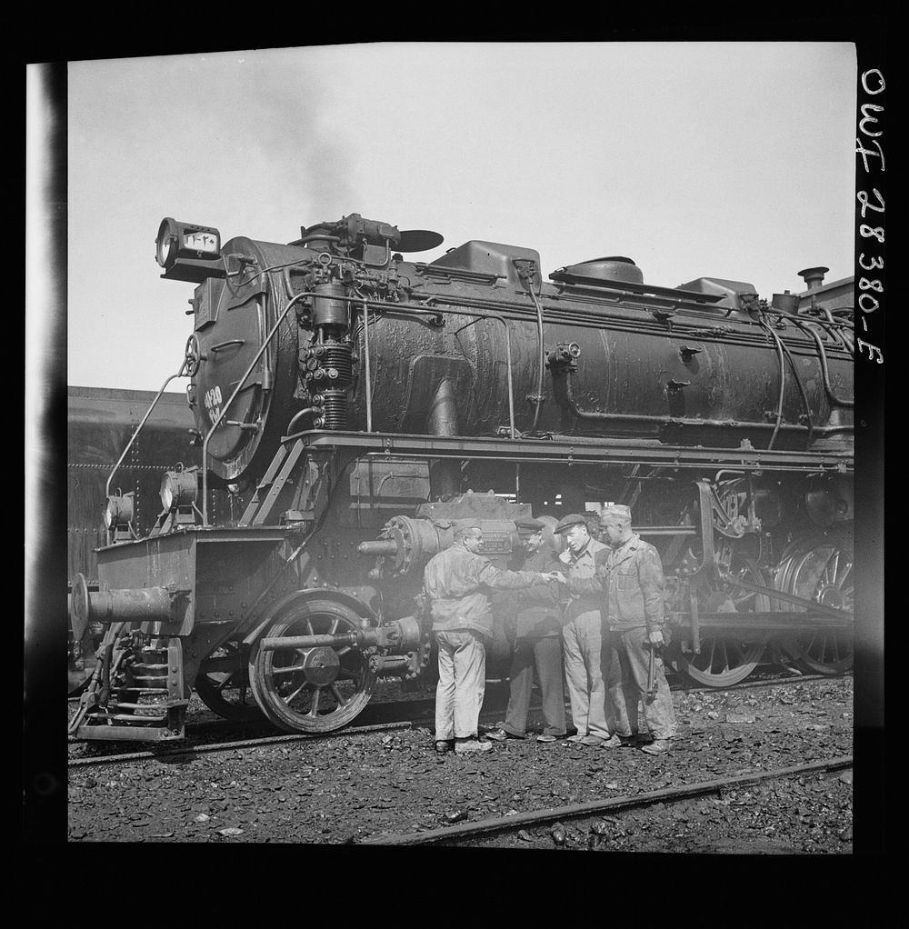 American and Russian railroad engineers are examining one of the German-made engines which are used to haul supplies to…