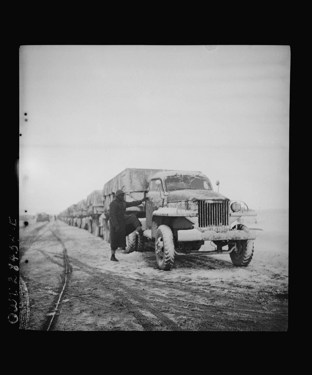 Somewhere in the Persian corridor. A United States Army truck convoy carrying supplies for Russia. Snow covered trucks start…