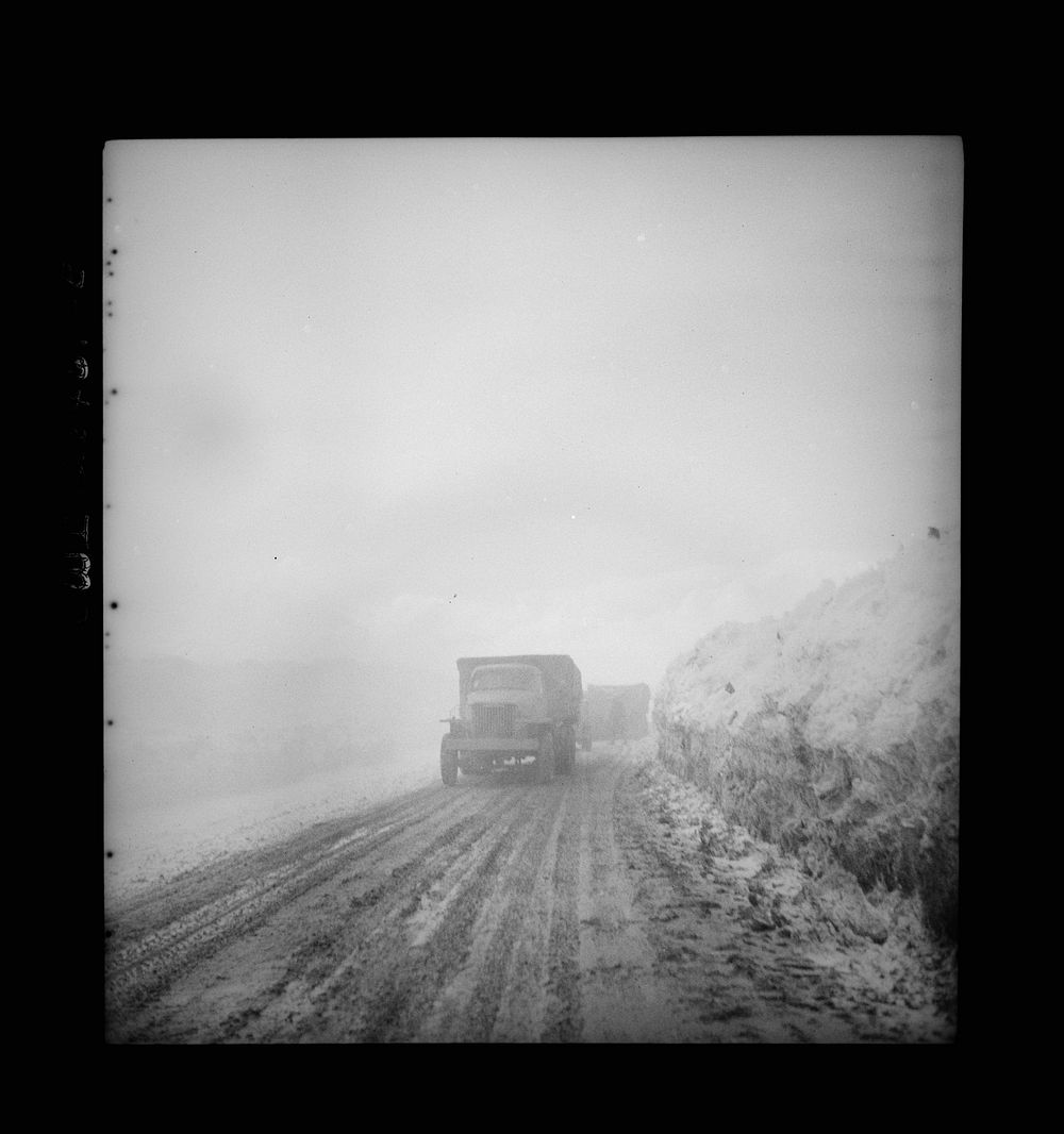 Somewhere in the Persian corridor. A United States Army truck convoy carrying supplies for Russia climbing into the clouds…