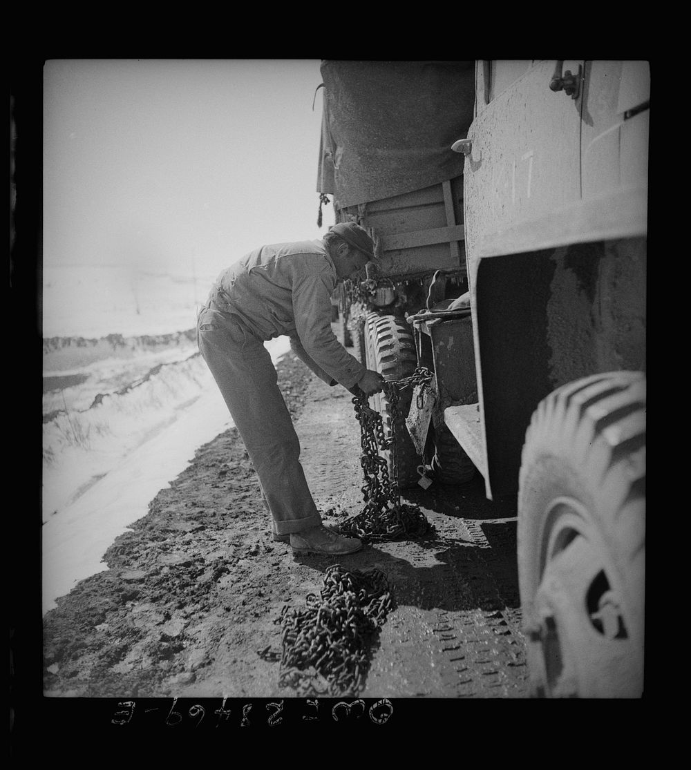 Somewhere in the Persian corridor. A United States Army truck convoy carrying supplies for Russia putting on chains as the…