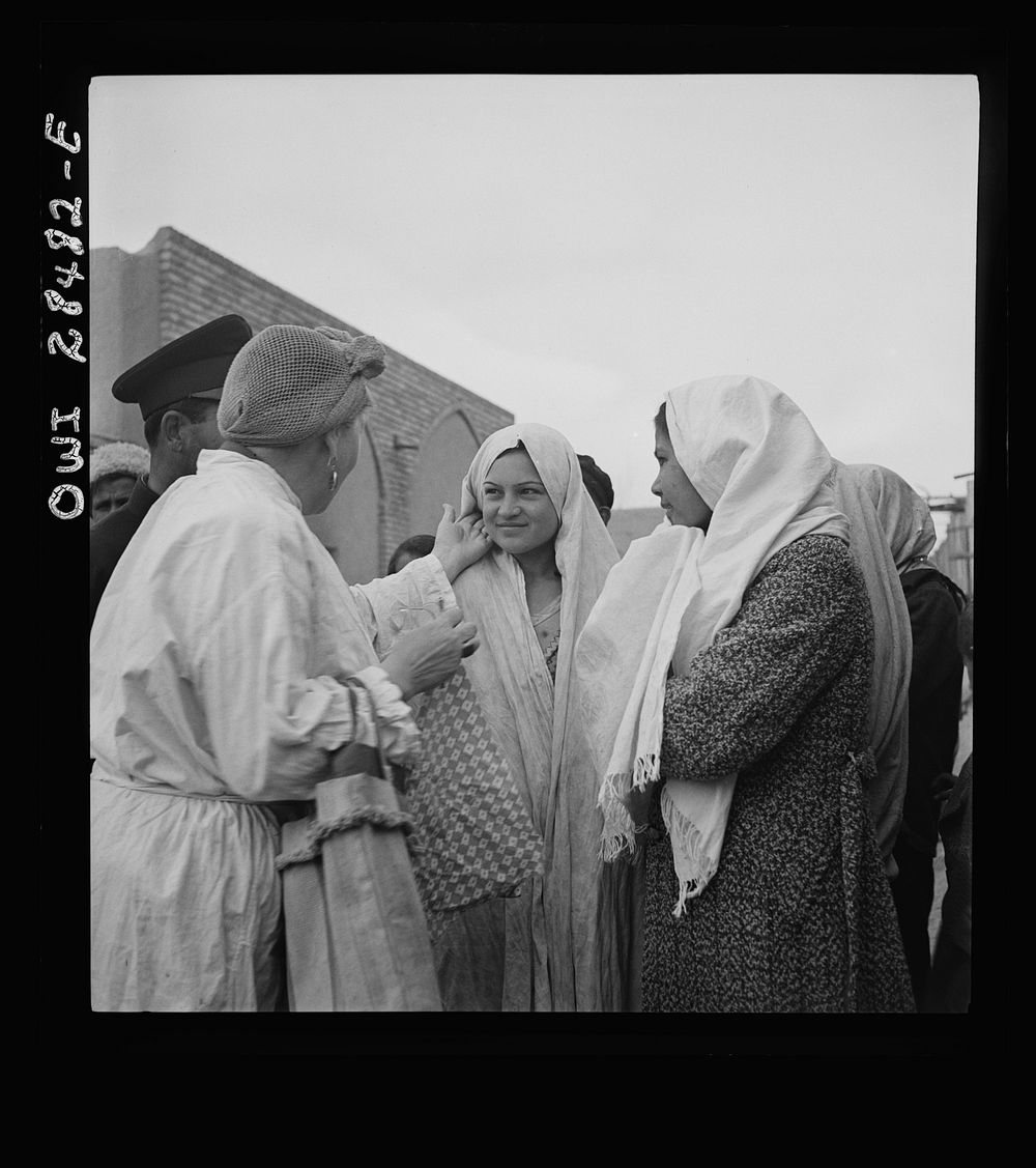 Teheran, Iran. Mrs. Louis Dreyfus, wife of the United States Minister to Iran, talking with native girls. Sourced from the…