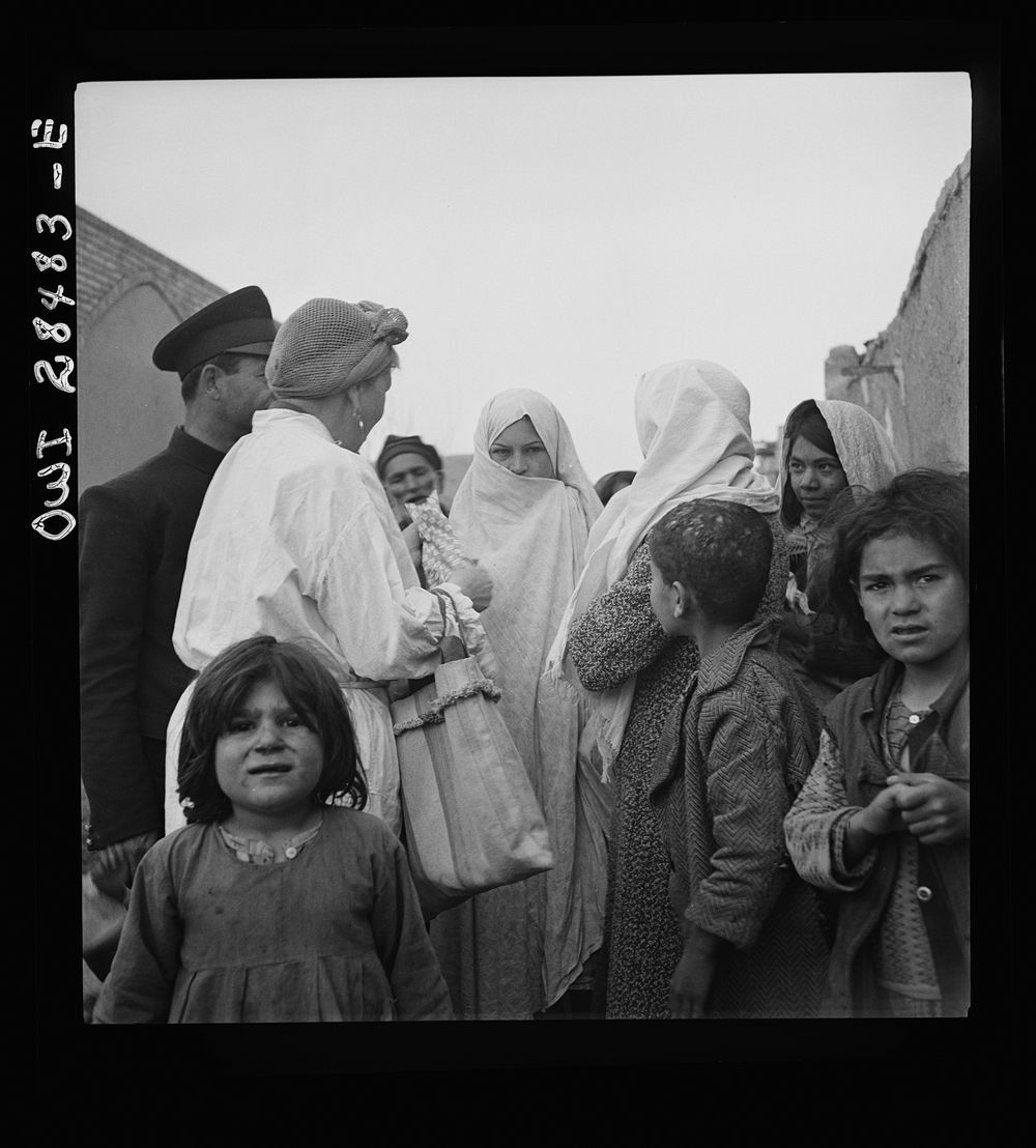 Teheran, Iran. Mrs. Louis Dreyfus, wife of the United States Minister to Iran, visiting in the poorer section of the city.…