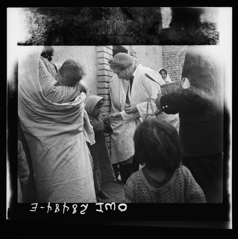 Teheran, Iran. Mrs. Louis Dreyfus, wife of the United States Minister to Iran, distributing food in the poorer section of…