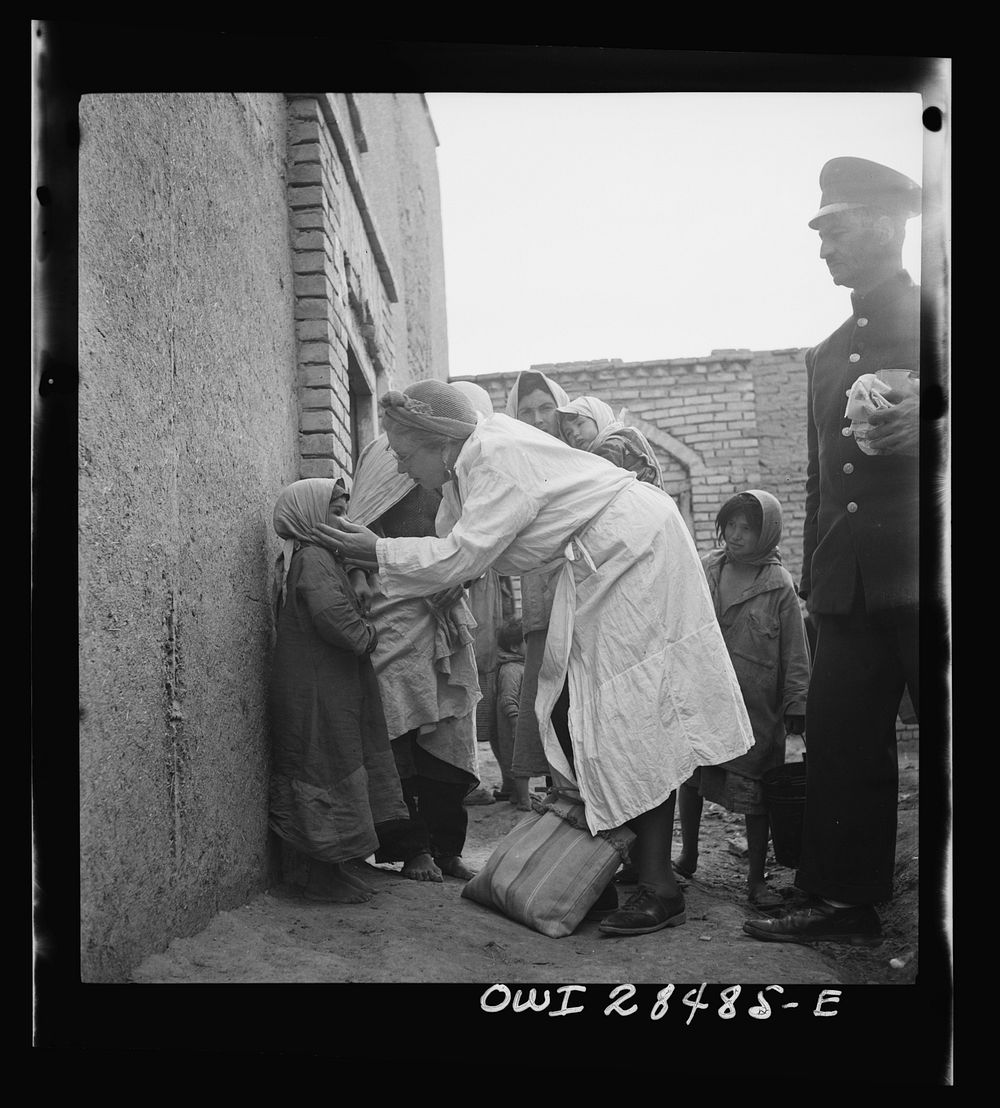 Teheran, Iran. Mrs. Louis Dreyfus, wife of the United States Minister to Iran, distributing food and medical supplies in the…