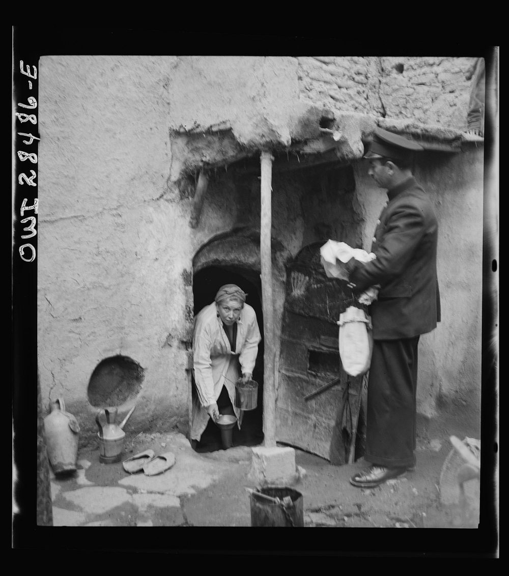 Teheran, Iran. Mrs. Louis Dreyfus, wife of the United States Minister to Iran, distributing food to natives. Sourced from…