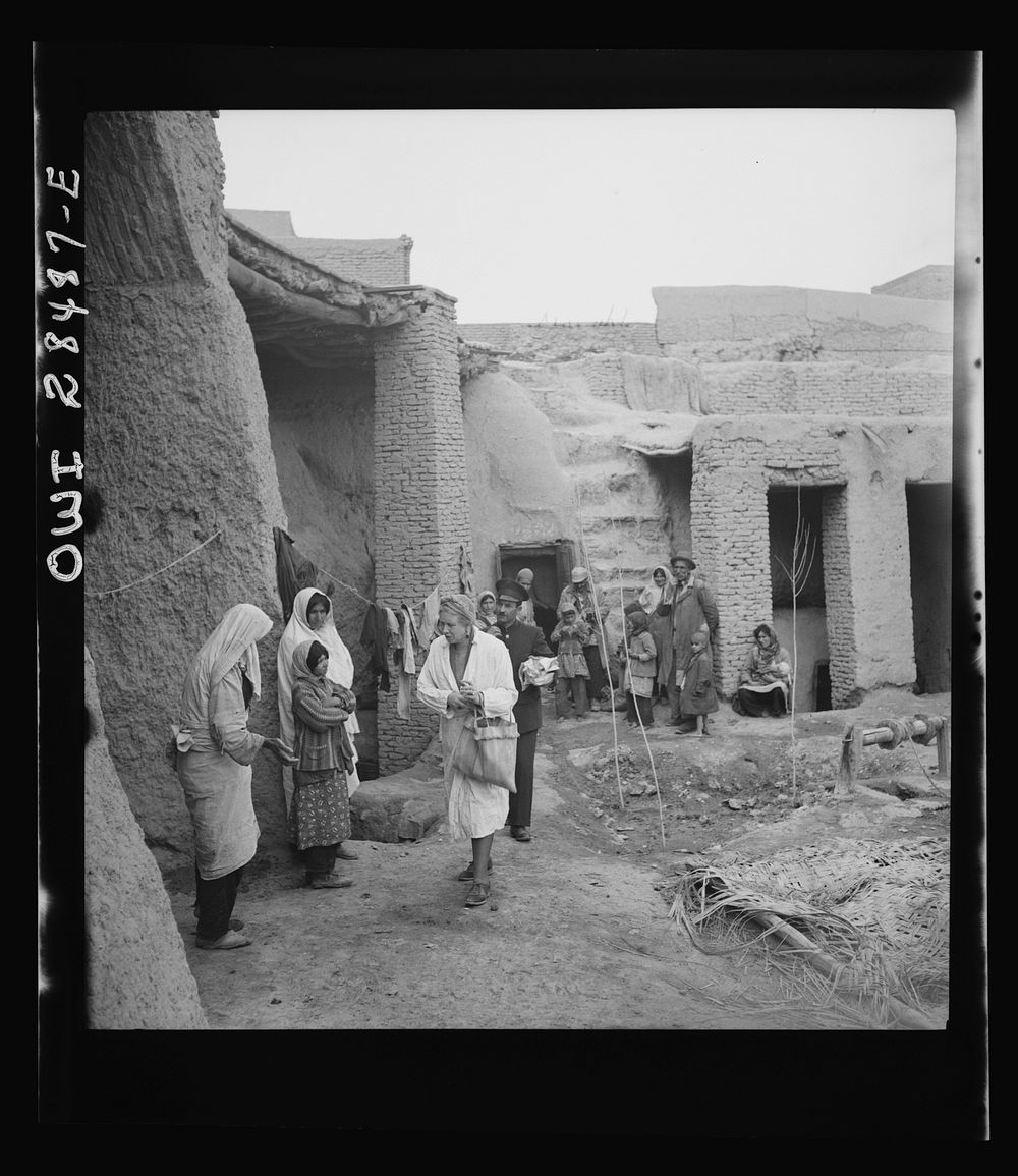 Teheran, Iran. Mrs. Louis Dreyfus, wife of the United States Minister to Iran, visiting a poor section and distributing…