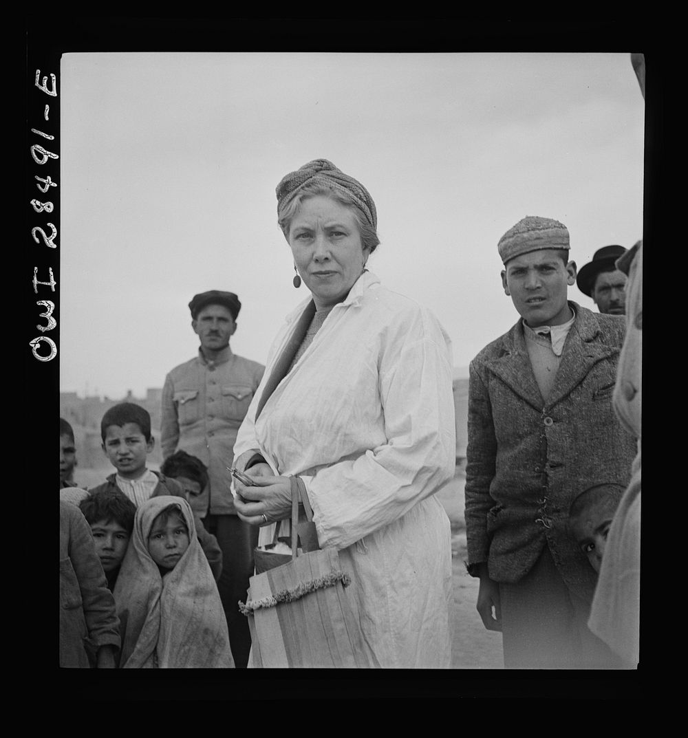 Teheran, Iran. Mrs. Louis Dreyfus, wife of the United States Minister to Iran, visiting a poor section of the city. Sourced…