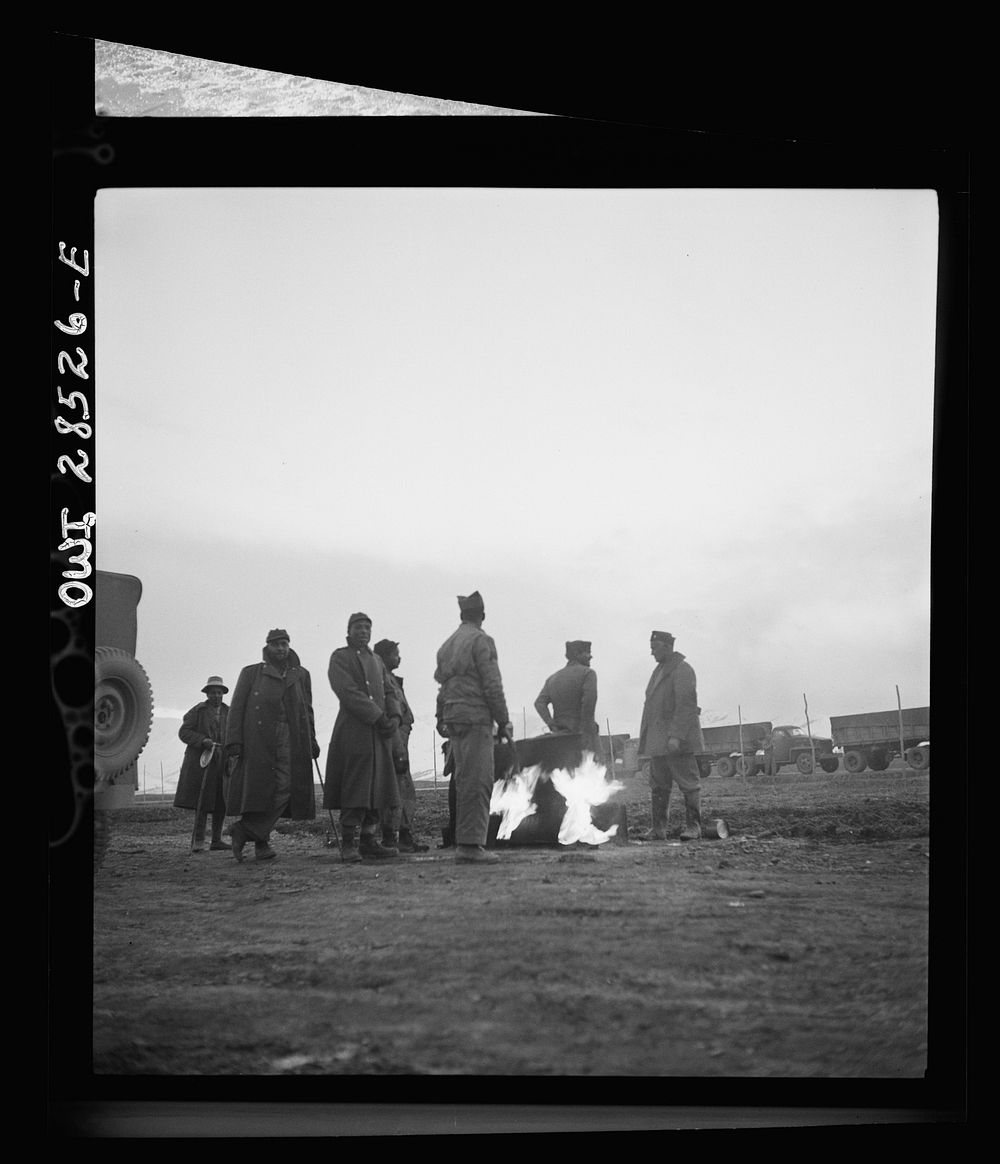 Somewhere in the Persian corridor. A United States Army truck convoy carrying supplies for Russia. Truck drivers standing…