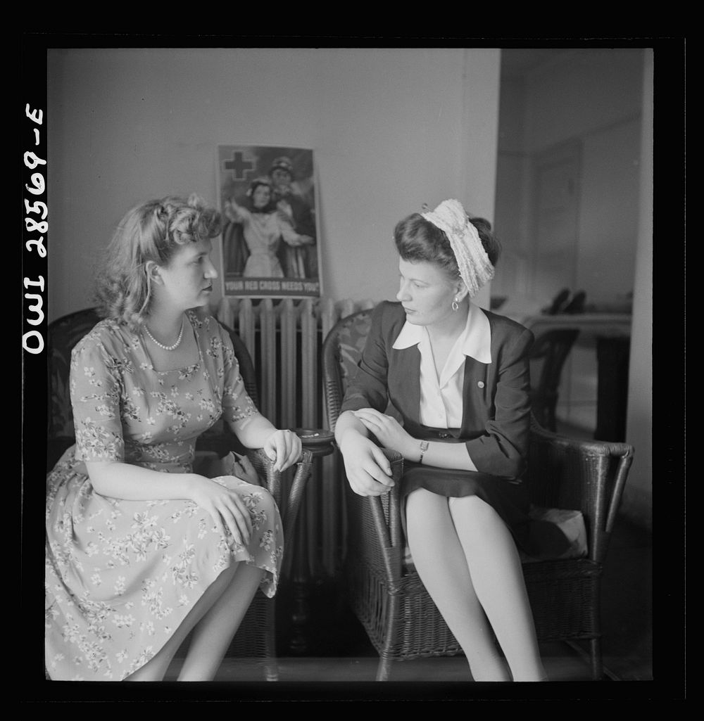 Washington, D.C. Two blood donors talking it over after having given a pint of blood. Note how girl on right holds cotton…