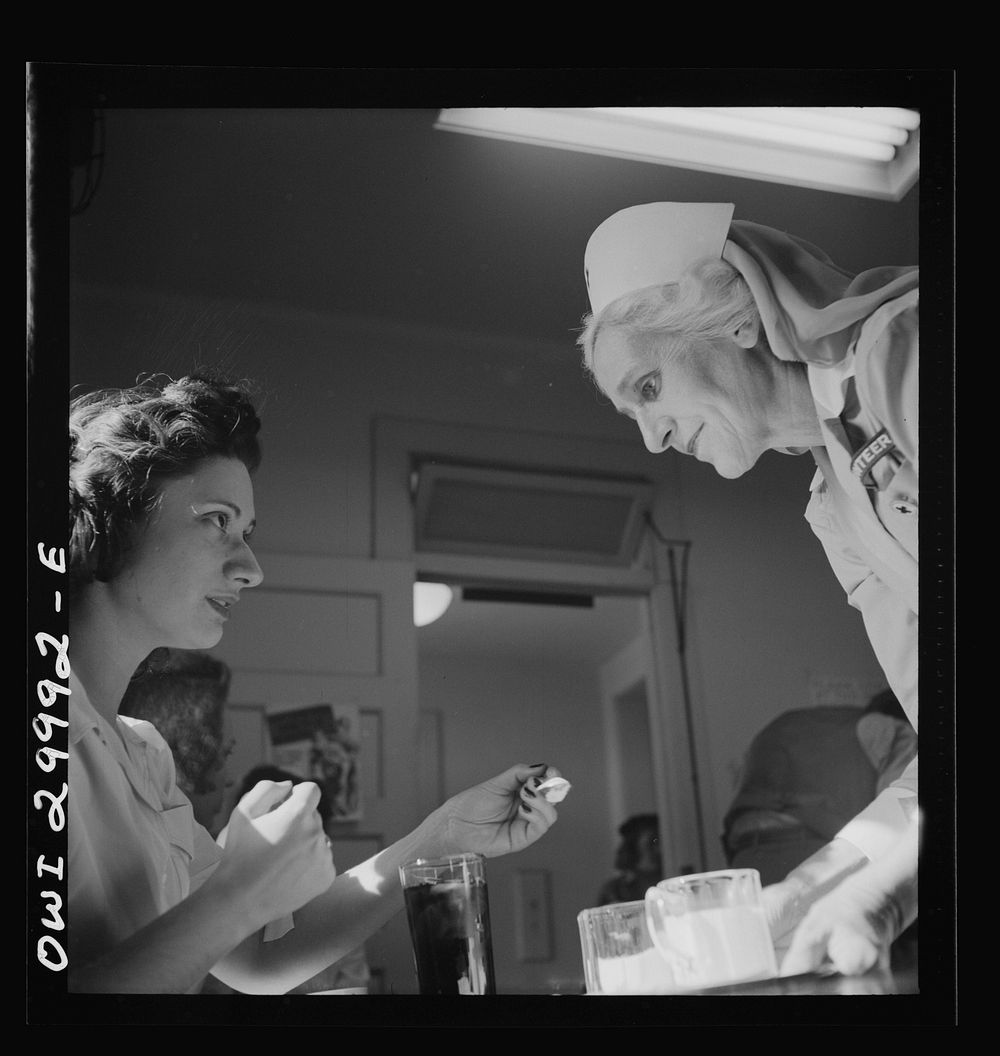 Washington, D.C. American Red Cross volunteer nurse's aide offering refreshments to a blood donor at the center. Sourced…