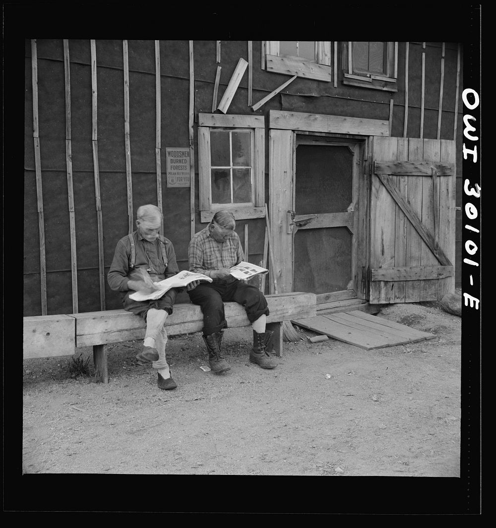Spring pulpwood drive on the Brown Company timber holdings in Maine. Woodsmen taking it easy in front of the bunkhouse…