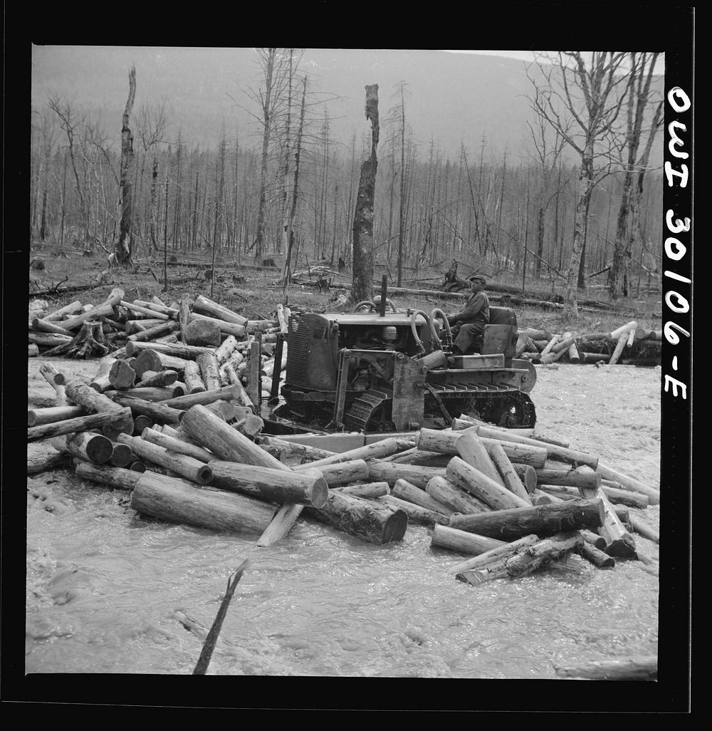 Spring pulpwood drive on the Brown Company timber holdings in Maine. Bulldozer clearing a channel in Dennison Bog Brook so…