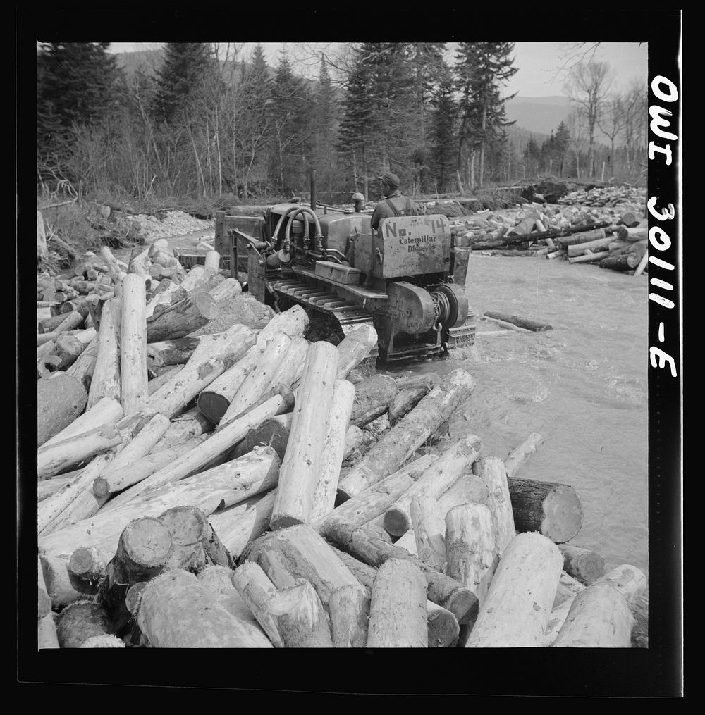 Spring pulpwood drive on the Brown Company timber holdings in Maine. Bulldozer clearing a channel in Dennison Bog Brook so…