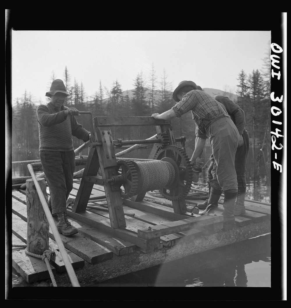 Spring pulpwood drive on the Brown Company timber holdings in Maine. Woodsmen winching up the boom on Long Pond; during the…
