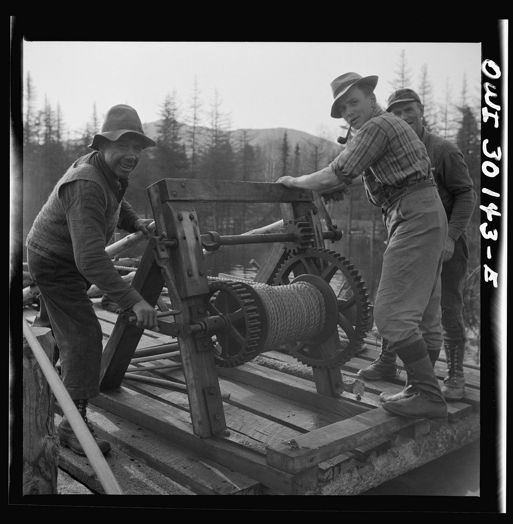 [Untitled photo, possibly related to: Spring pulpwood drive on the Brown Company timber holdings in Maine. Woodsmen winching…