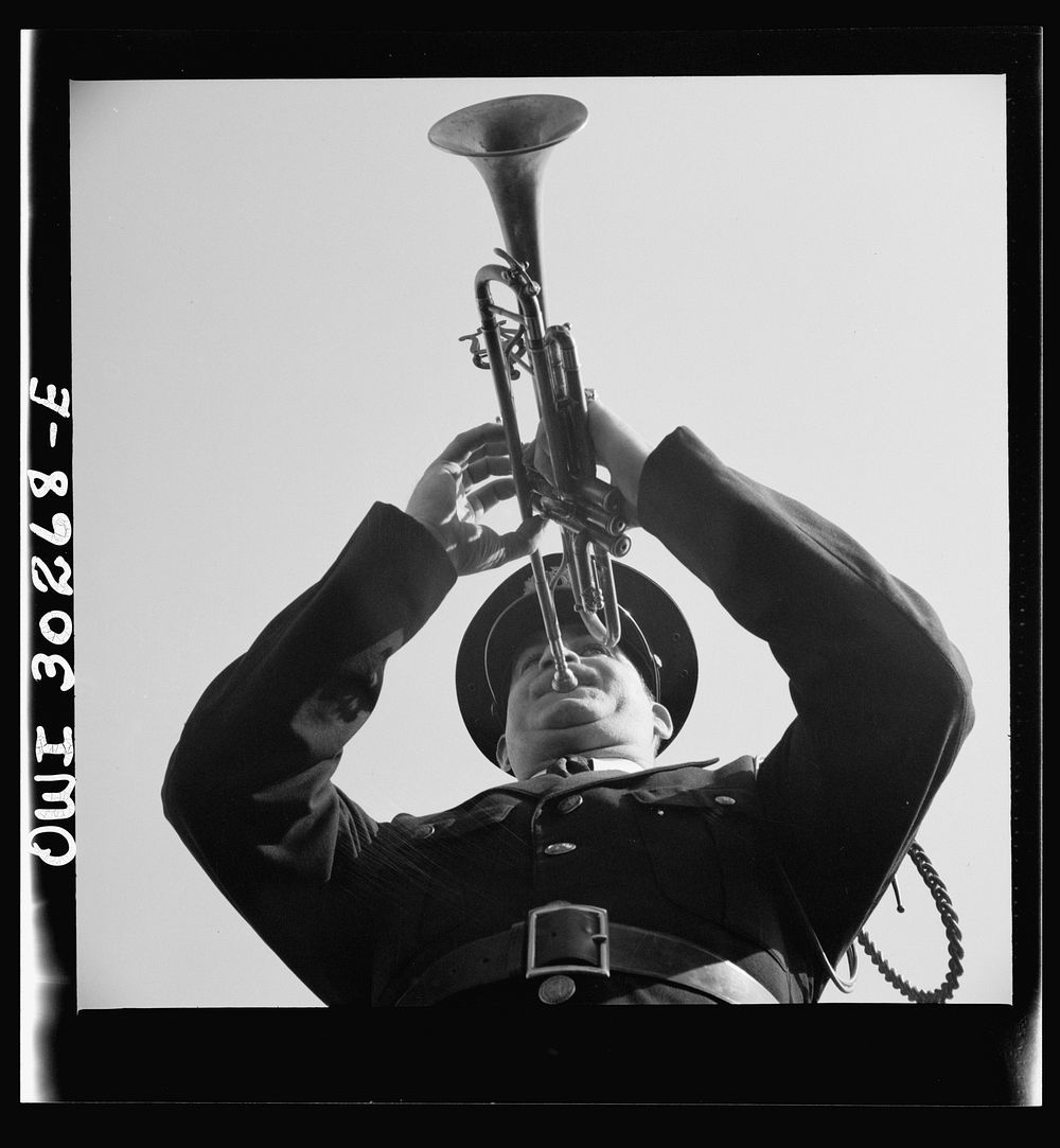 Gloucester, Massachusetts. Memorial Day, 1943. A Legionaire sounding taps for the War dead during services. Sourced from the…