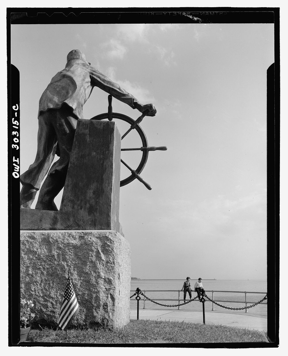 Gloucester, Massachusetts. The bronze fisherman, a memorial to men lost at sea. Each year flowers are placed at the feet of…