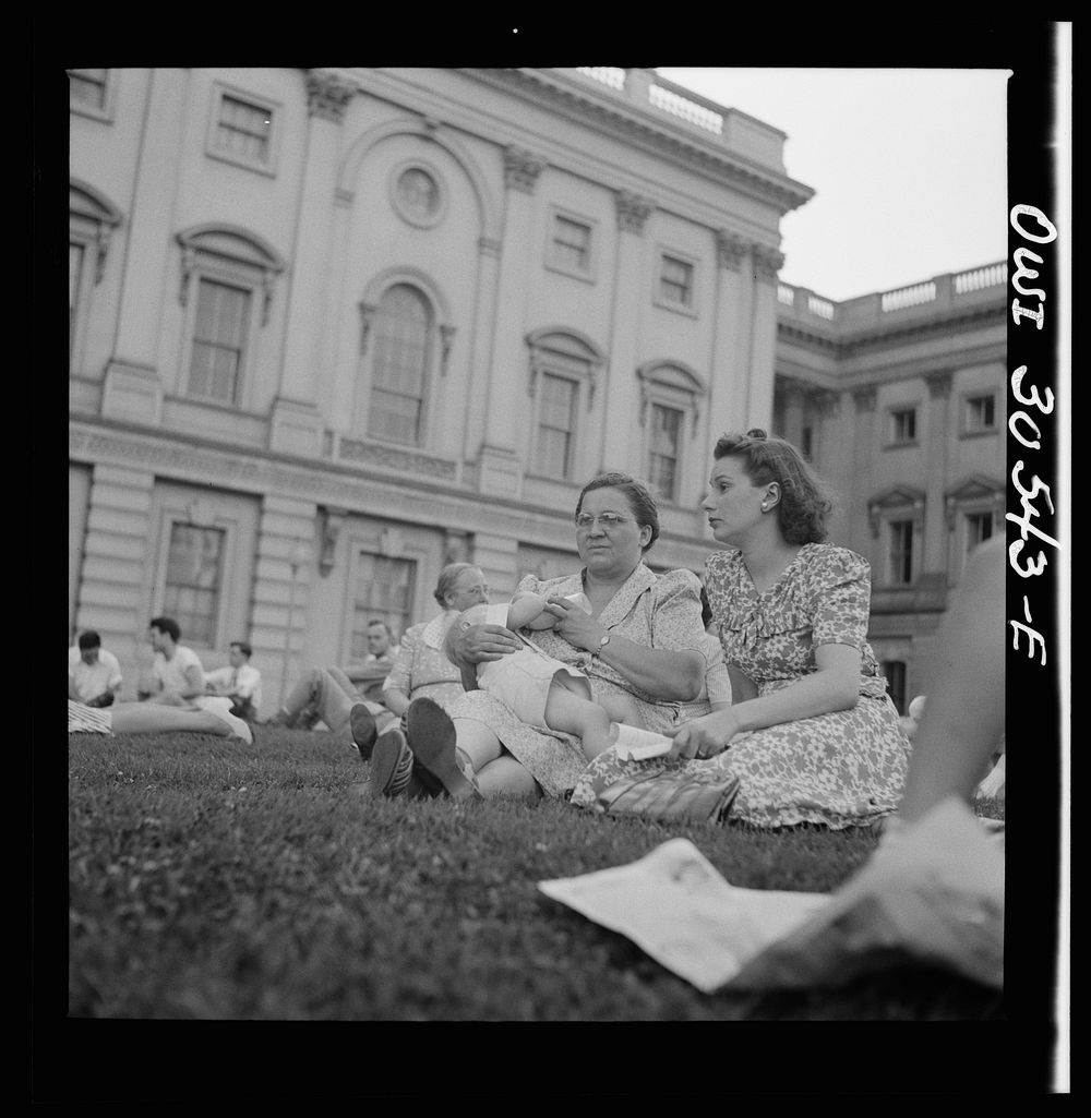 [Untitled photo, possibly related to: Washington, D.C. Mother, wife, and son of a trumpet player in the U.S. Army band at a…