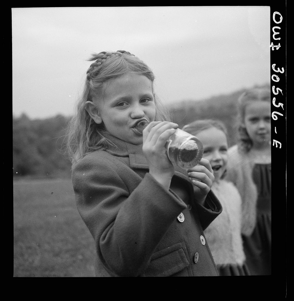 Pittsburgh, Pennsylvania. A child drinking Pepsi Cola before the service held on Memorial Day at the Lithuanian cemetery.…