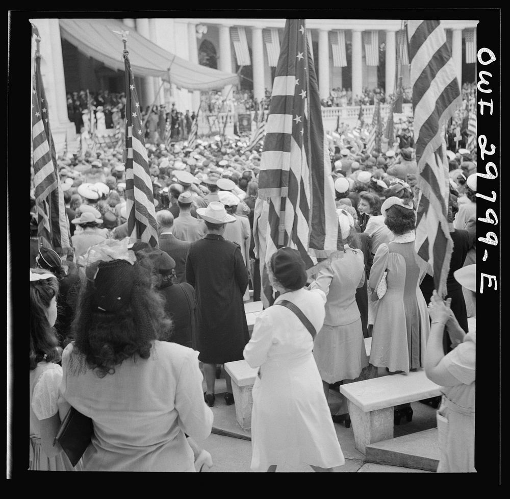 [Untitled photo, possibly related to: Arlington Cemetery, Arlington, Virginia. Spectators putting up umbrellas as a light…
