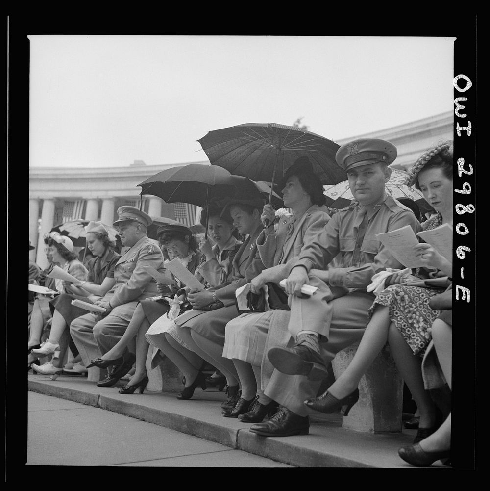 Arlington Cemetery, Arlington, Virginia. Spectators putting up umbrellas as a light rain starts falling at the Memorial Day…