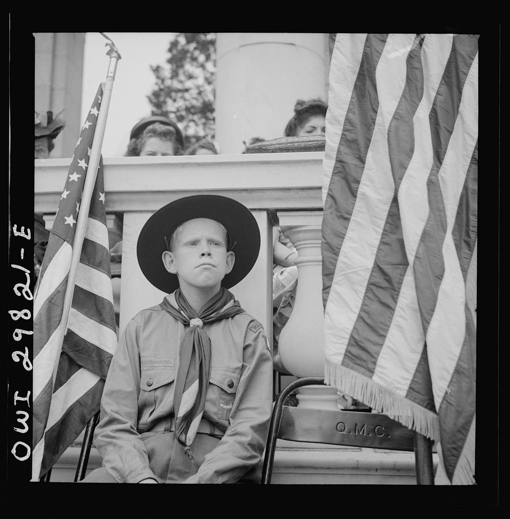 [Untitled photo, possibly related to: Arlington Cemetery, Arlington, Virginia. Boy scout color bearer listening to the…
