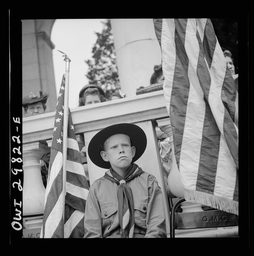 [Untitled photo, possibly related to: Arlington Cemetery, Arlington, Virginia. Boy scout color bearer listening to the…