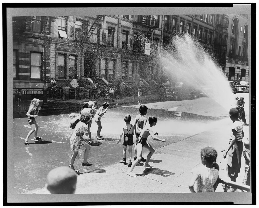 New York, New York. Children escape the heat of the East Side by using fire hydrant as a shower bath. Sourced from the…