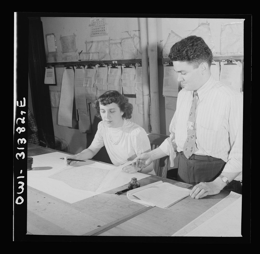 Washington, D.C. Preparing an advisory forecast at the U.S. Weather Bureau. Sectional manuscript maps are distributed to…