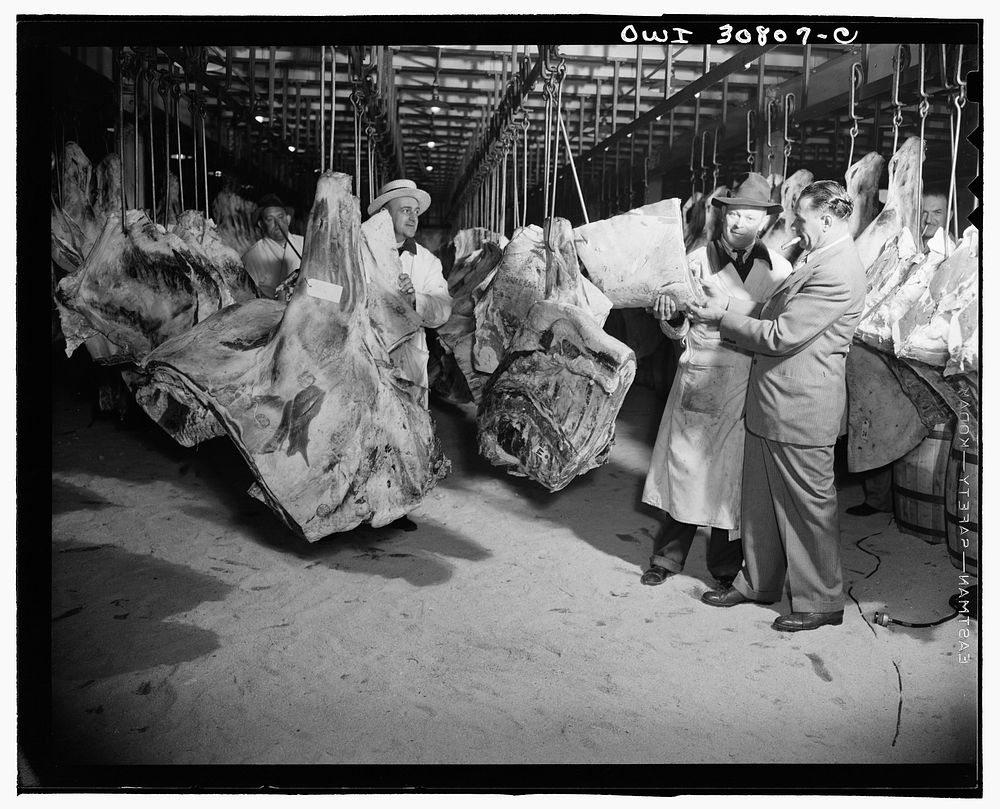A scene in a wholesale meat market. A reconstruction photographed during the filming of "Black Marketing," a motion picture…
