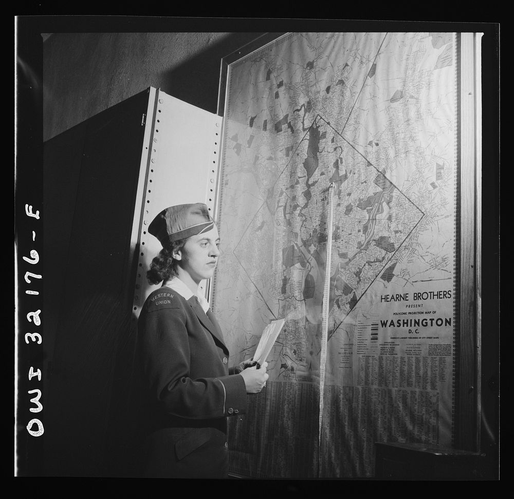 Washington, D.C. Miss Dorothy Lutz checking a map before she starts to deliver telegrams. Sourced from the Library of…