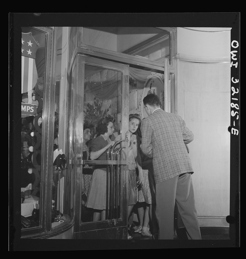 Washington, D.C. A shoe store clerk opening the door to customers on the last day on which war ration shoe coupon seventeen…