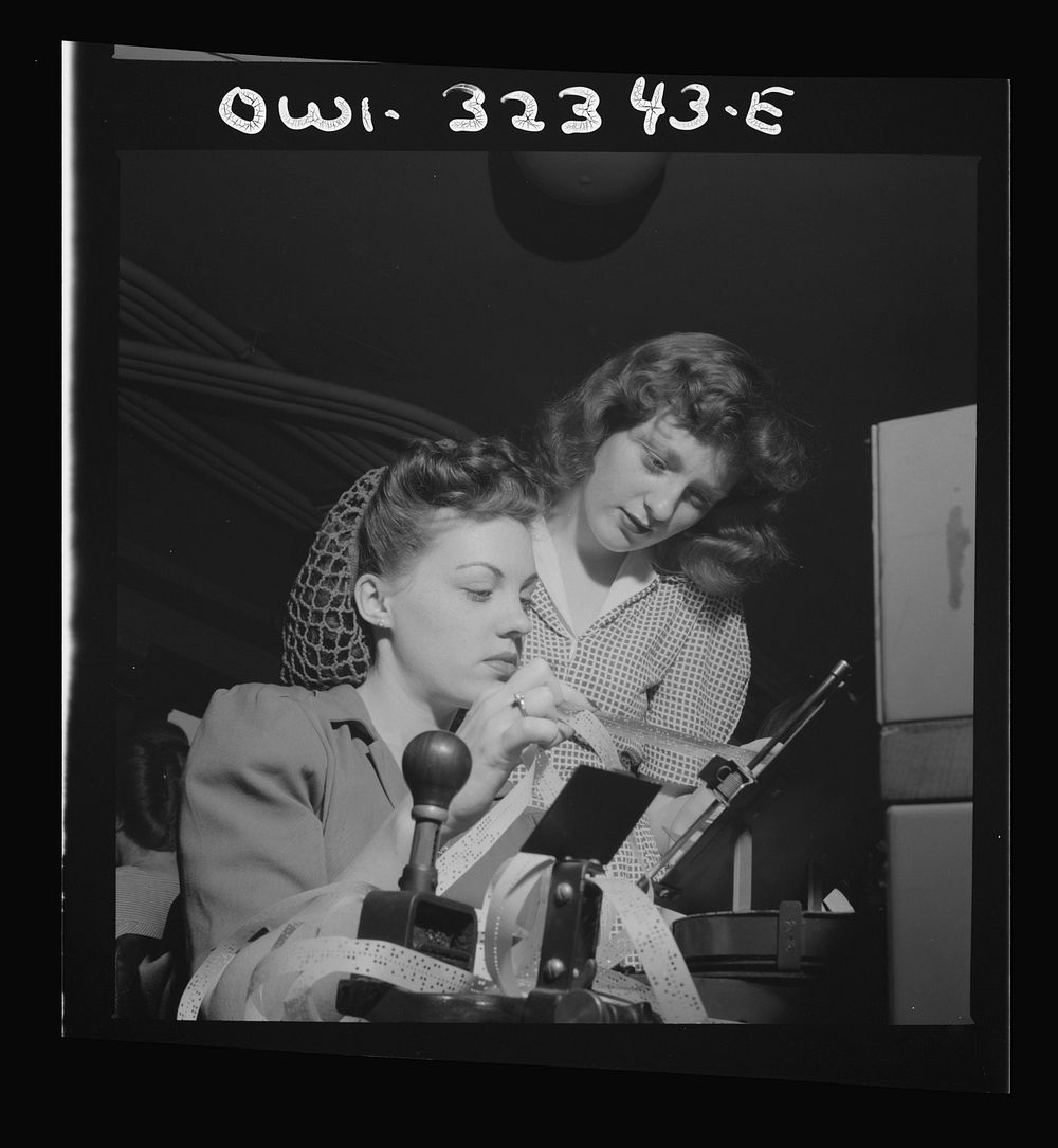 Washington, D.C. Benie Lee Neal and Patricia Kaufman are checking the perforated tape at the Western Union telegraph office.…