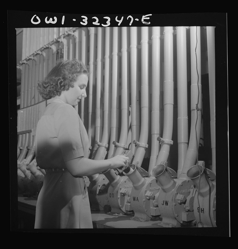 Washington, D.C. Miss Helen Ringwald works with the pneumatic tubes through which messages are sent to branches in other…