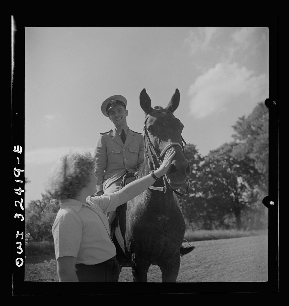 Oswego, New York. Polish naval officer riding a horse at a farm where the heroes were entertained during United Nations…
