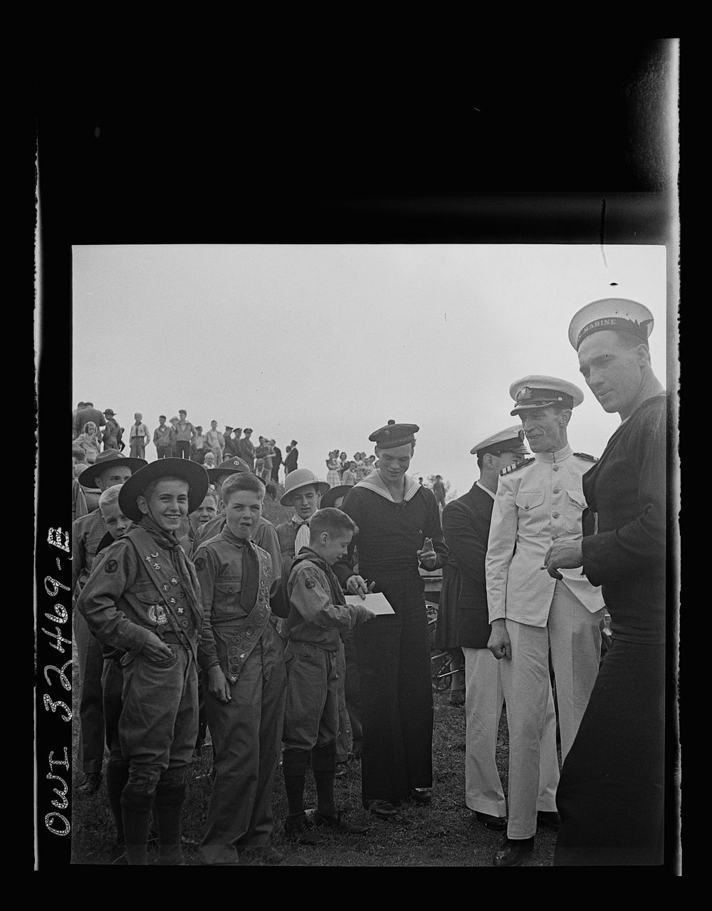 [Untitled photo, possibly related to: Oswego, New York. Boy scouts getting autographs from the United Nations heroes on Flag…