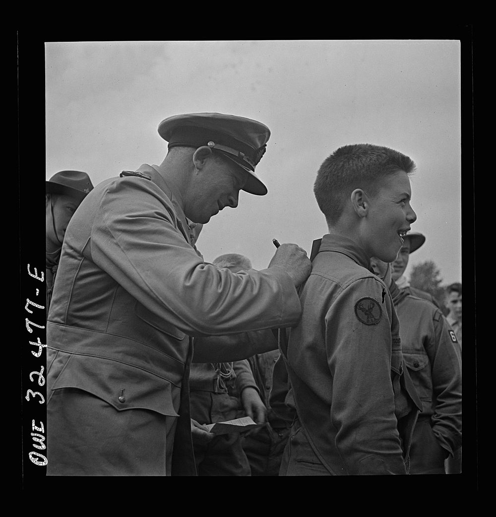 Oswego, New York. A Norwegian naval officer writing his autograph for a boy scout during United Nations week. Sourced from…