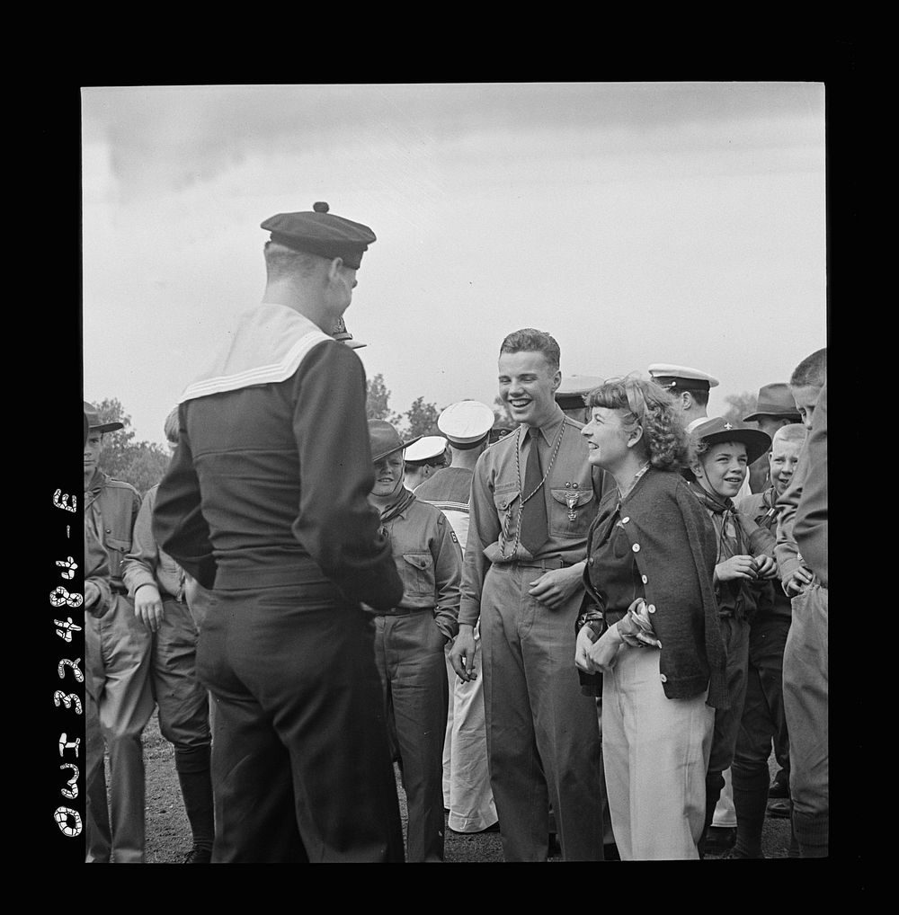[Untitled photo, possibly related to: Oswego, New York. Boy scout giving an insignia to a Norwegian naval officer and sailor…