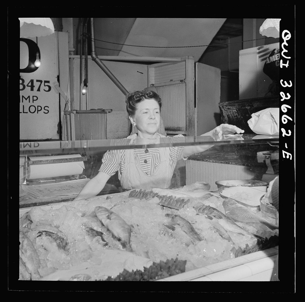Washington, D.C. Blanche Beavers waiting on a customer in the Arcade seafood market. Sourced from the Library of Congress.