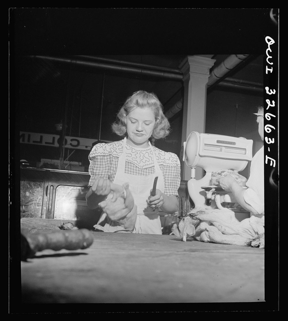[Untitled photo, possibly related to: Washington, D.C. Betty Jane Colbert, a worker at the Arcade butcher shop, dismembering…