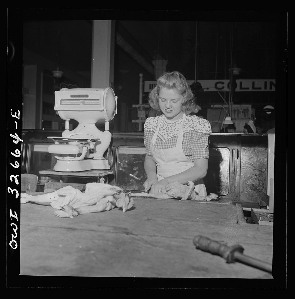 Washington, D.C. Betty Jane Colbert, a worker at the Arcade butcher shop, dismembering a chicken. Sourced from the Library…