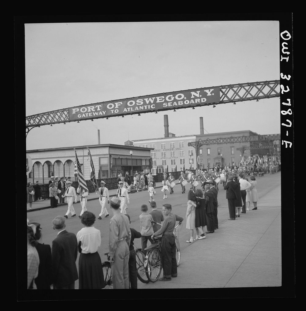 [Untitled photo, possibly related to: Oswego, New York. United Nations heroes marching behind the boy scouts carrying flags…