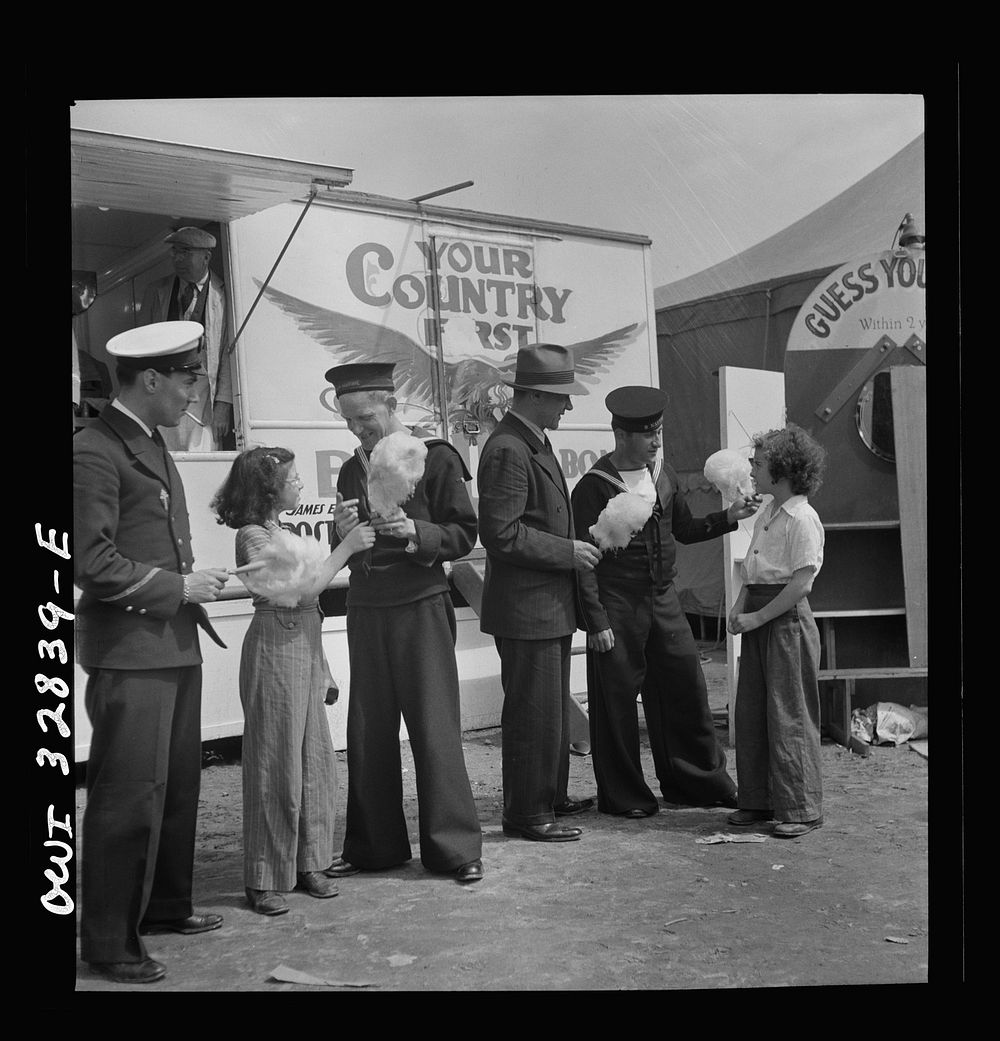 [Untitled photo, possibly related to: Oswego, New York. A Belgian sailor giving sponge sugar to a little girl at the…