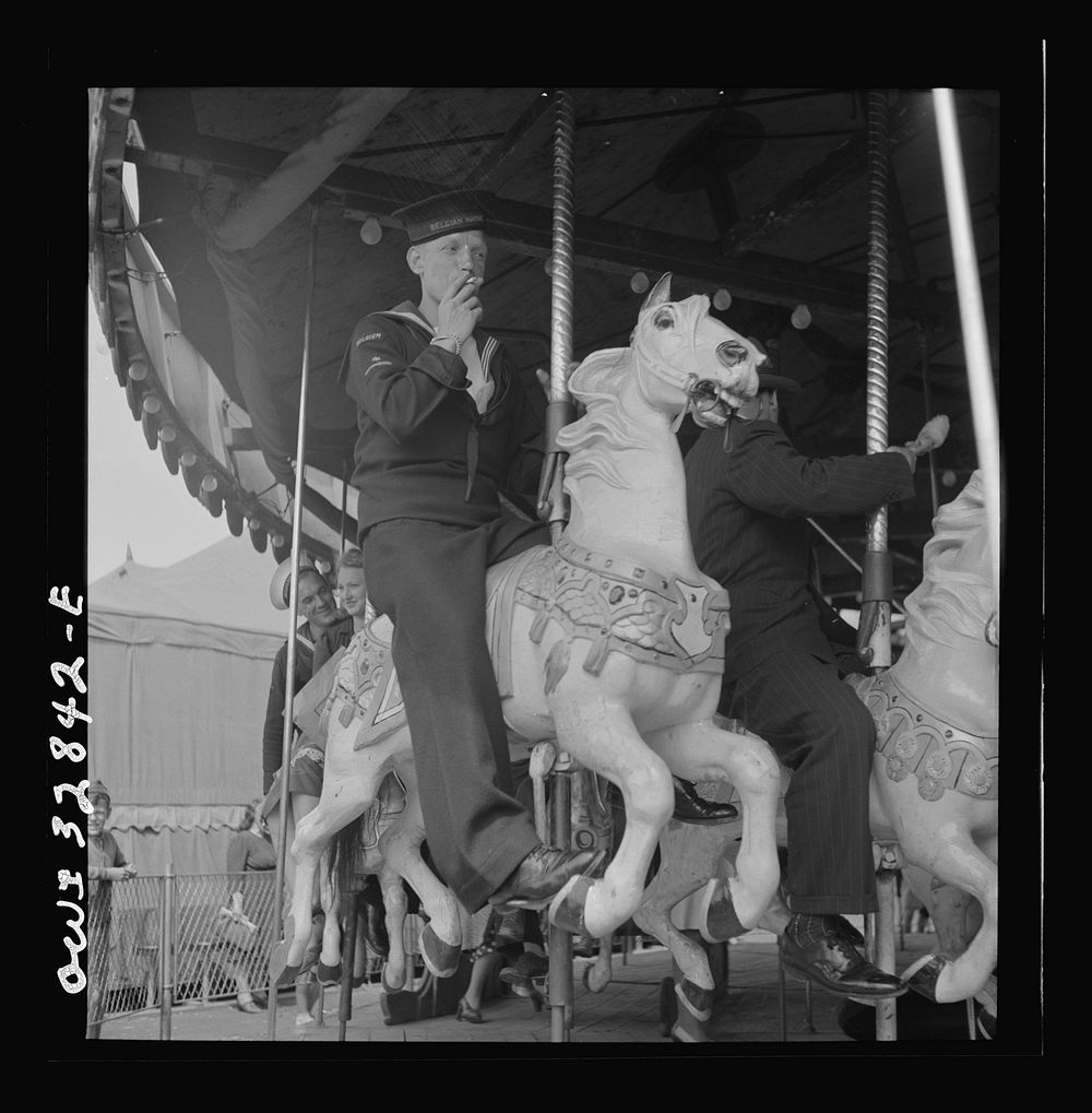 Oswego, New York. A Belgian sailor on the merry-go-round at the carnival during United Nations week. Sourced from the…