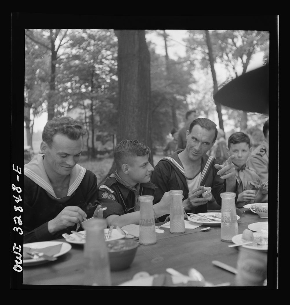 Oswego, New York. Norwegian and Belgian sailors having lunch at the boy scout outing during United Nations week. Sourced…