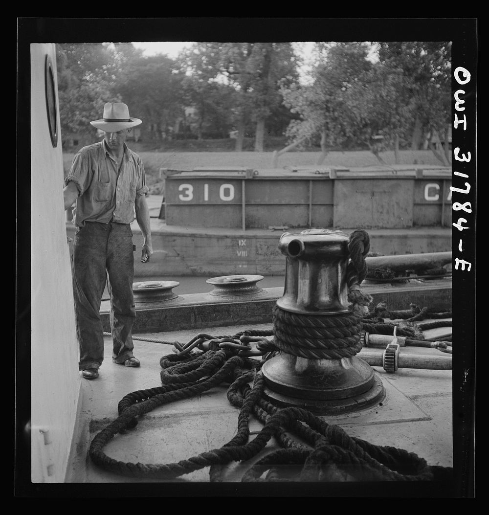 A power-driven winch for taking up slack in the rope aboard the towboat Ernest T. Weir going down the Ohio River to…