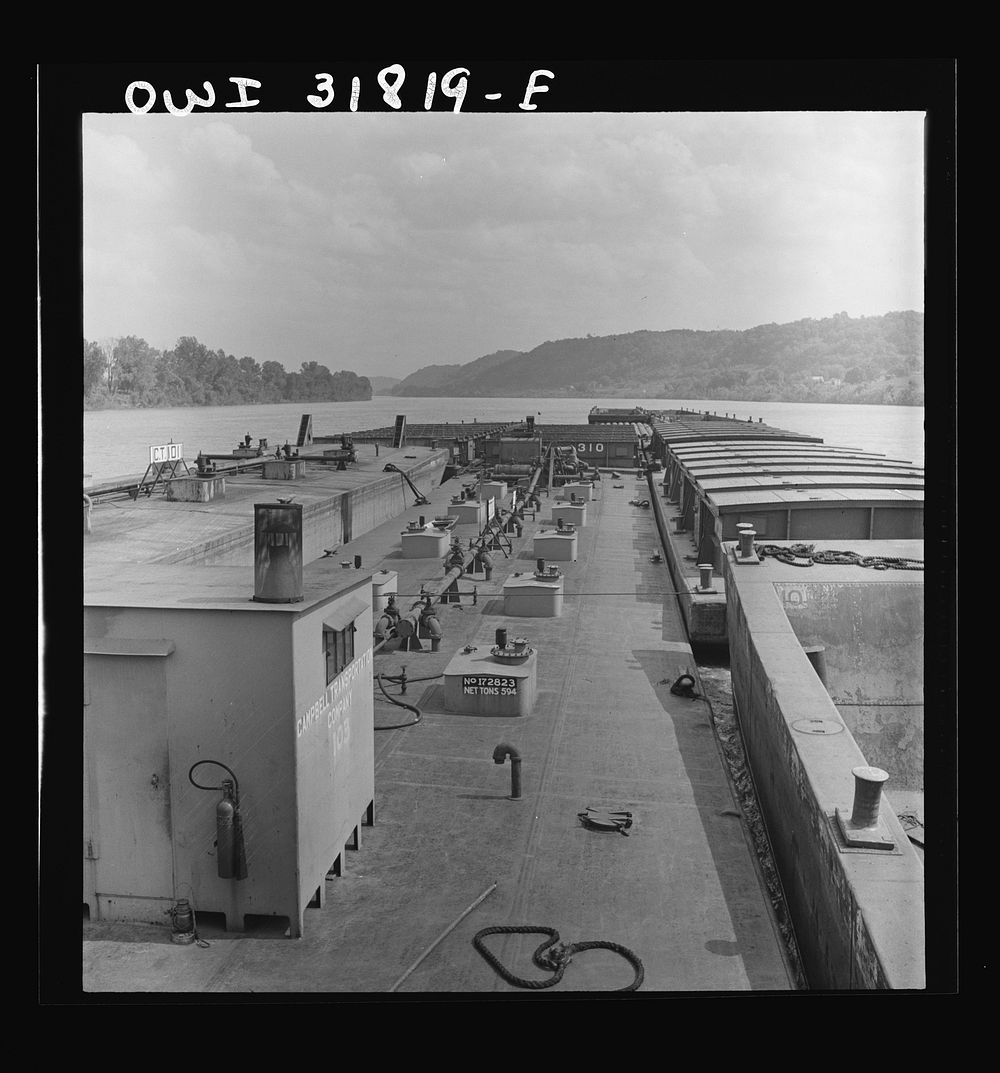 [Untitled photo, possibly related to: Barges in the tow of the towboat Ernest T. Weir going down the Ohio River to…