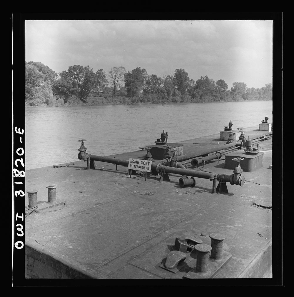 Detail of an oil barge in the tow of the towboat Ernest T. Weir going down the Ohio River to Cincinnati. Sourced from the…