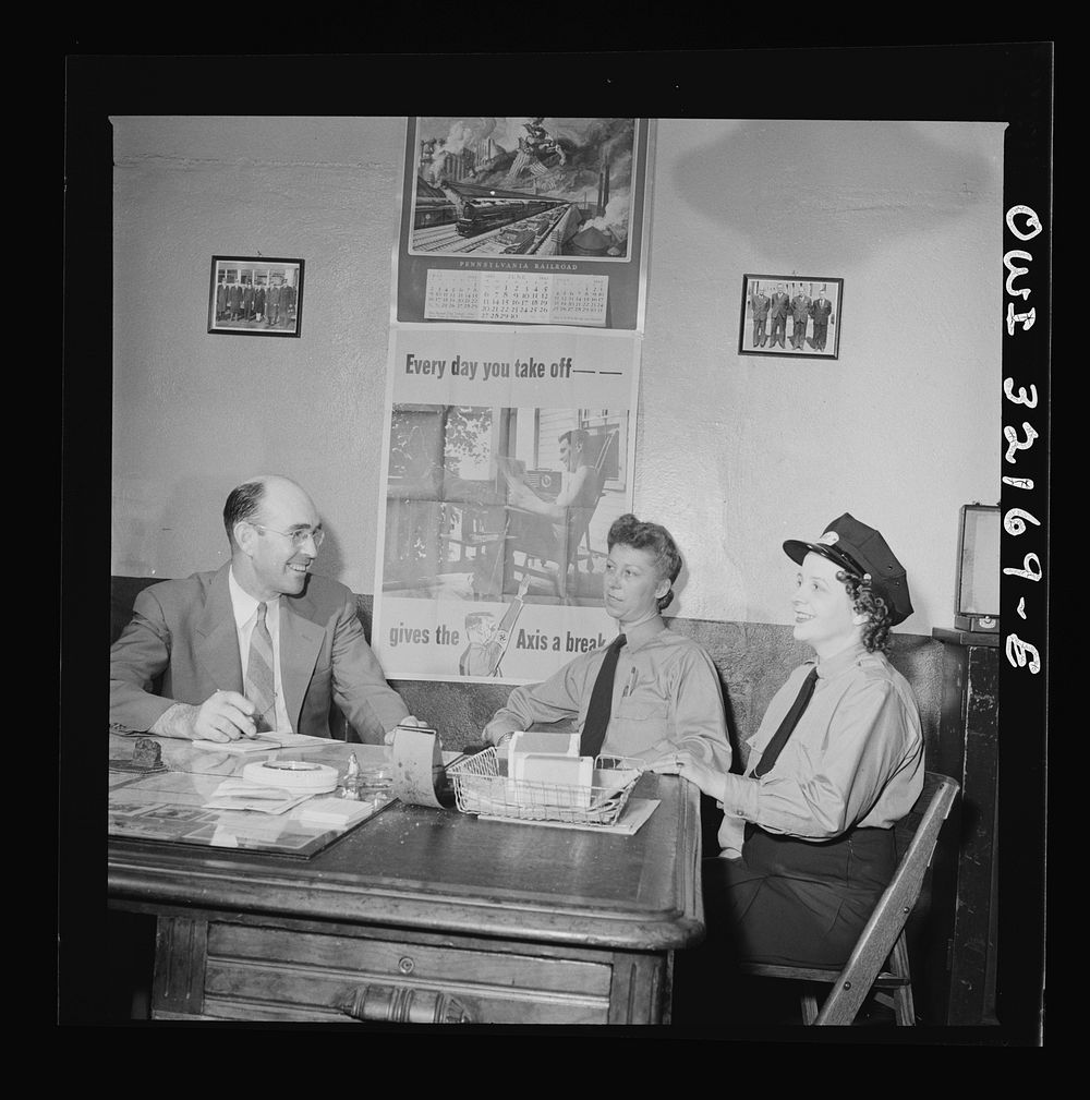 Washington, D.C. Women streetcar and bus operators Hattie B. Sheehan and Frances Lewis talking to Superintendent Henshaw of…